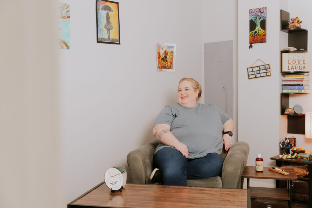 A woman sits in a comfortable chair as she discusses our program for medical weight loss in Gun Barrel City, TX, with a provider who sits off screen.